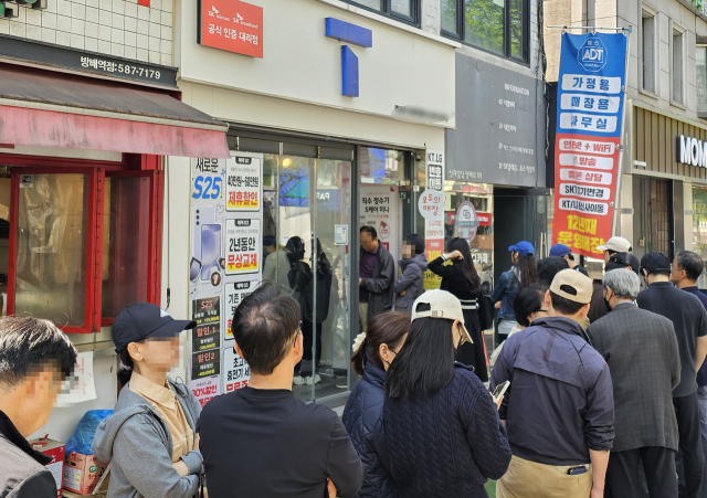 지난 26일 서울 시내 한 SKT 대리점에서 고객들이 유심을 교체하기 위해 줄을 서 기다리고 있다. 연합뉴스