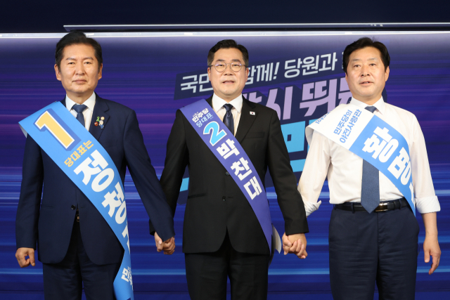 더불어민주당 정청래(왼쪽)·박찬대(가운데) 당대표 후보, 황명선 최고위원 후보가 20일 서울 여의도 당사에서 열린 8·2 전당대회 순회 경선 영남권 합동연설회에서 손을 잡고 인사하고 있다. 연합뉴스