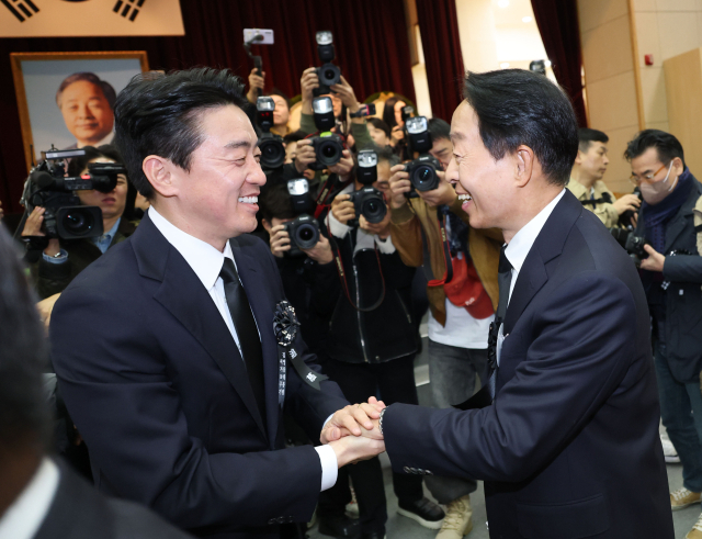 강훈식 대통령 비서실장과 김영삼 전 대통령 아들 김현철 씨가 21일 서울 동작구 국립서울현충원에서 열린 고 김영삼 전 대통령 서거 10주기 추모식에서 인사를 나누고 있다. 연합뉴스