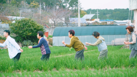 쪽파밭에서 ‘파도 치유 체조’ 중 쪽파 뽑기 동작을 시연하고 있다. 문동생활권 어촌신활력증진사업 앵커조직 제공