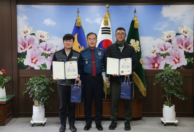 13일 김종철(가운데) 경남경찰청장이 고속도로 교통사고 인명 구조에 나선 배극찬(맨 왼쪽) 씨와 김범수(맨 오른쪽) 씨에게 감사장을 전달하고 기념 사진을 찍고 있다. 경남경찰청 제공
