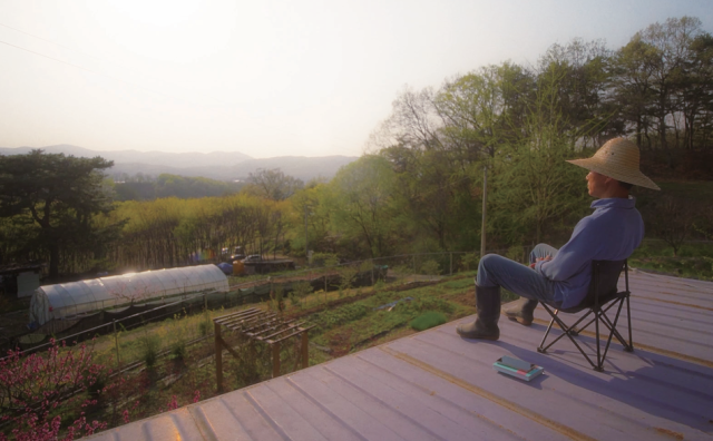 ‘푸바오 할부지’로 알려진 강철원 주키퍼가 자신의 텃밭을 바라보고 있는 모습. 한스미디어 제공